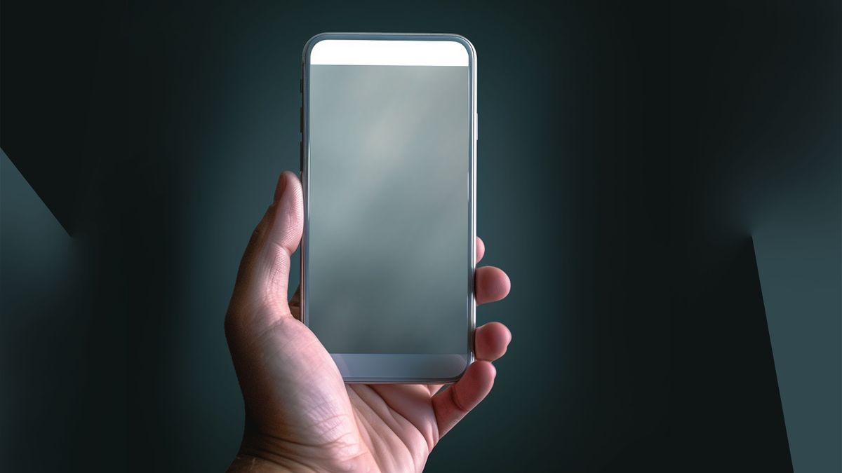 Close-up of hand holding sleek modern smartphone checking device storage diagnostics
